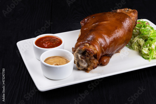 Tasty pork knuckle with sau...