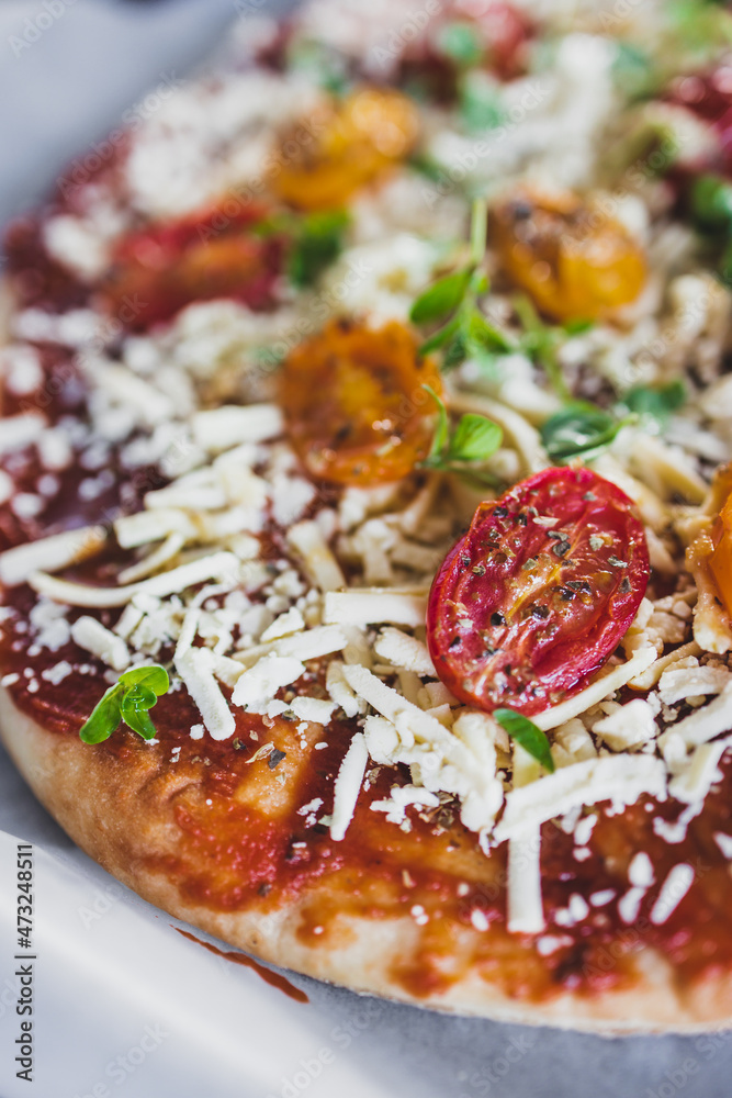 vegan margerita pizza with roasted cherry toatoes and dairy-free cheese, healthy plant-based food vegan margerita pizza with roasted cherry toatoes and dairy-free cheese, healthy plant-based food