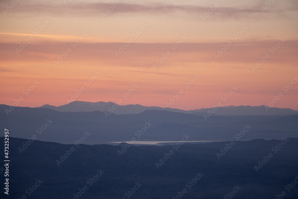 sunset over the west desert with the mountains of utah and Nevada in the distance