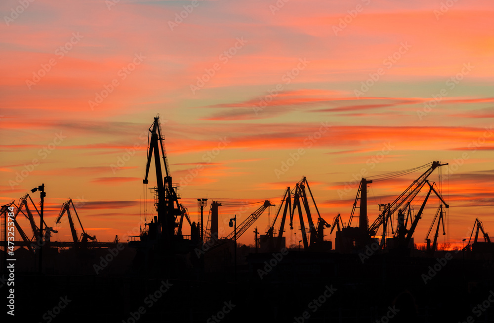 landscape with the silhouettes of cranes from the port of Constanta in the evening landscape with the silhouettes of cranes from the port of Constanta in the evening