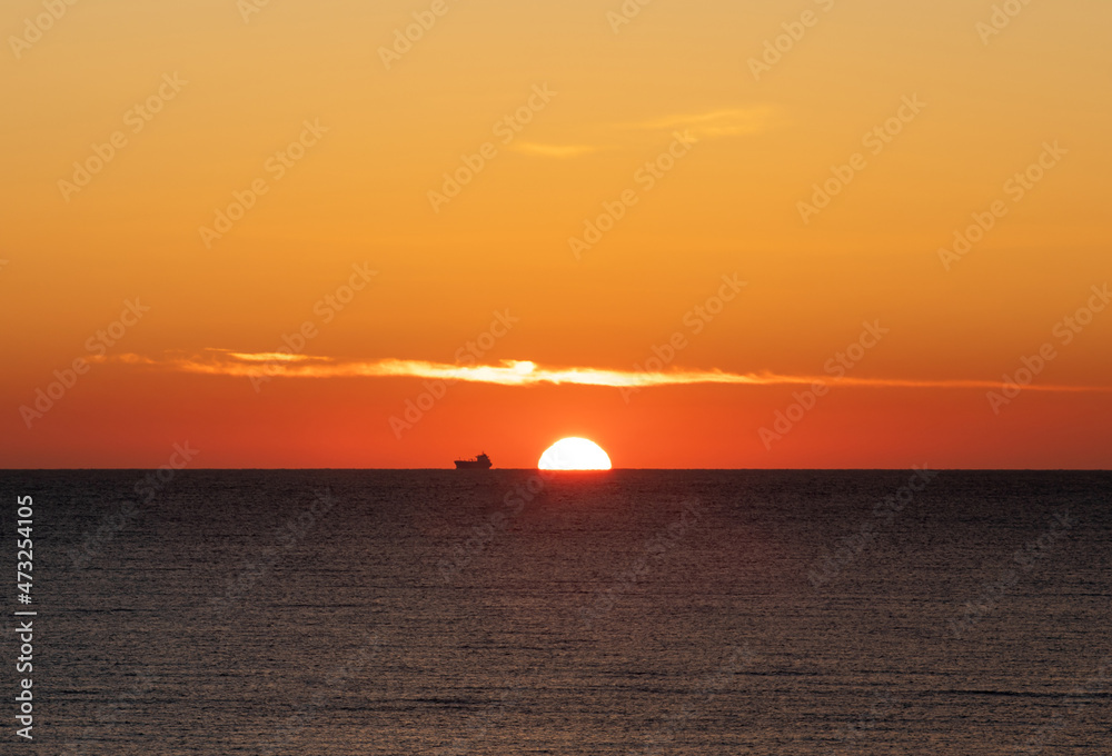 a sunrise on the ocean shore