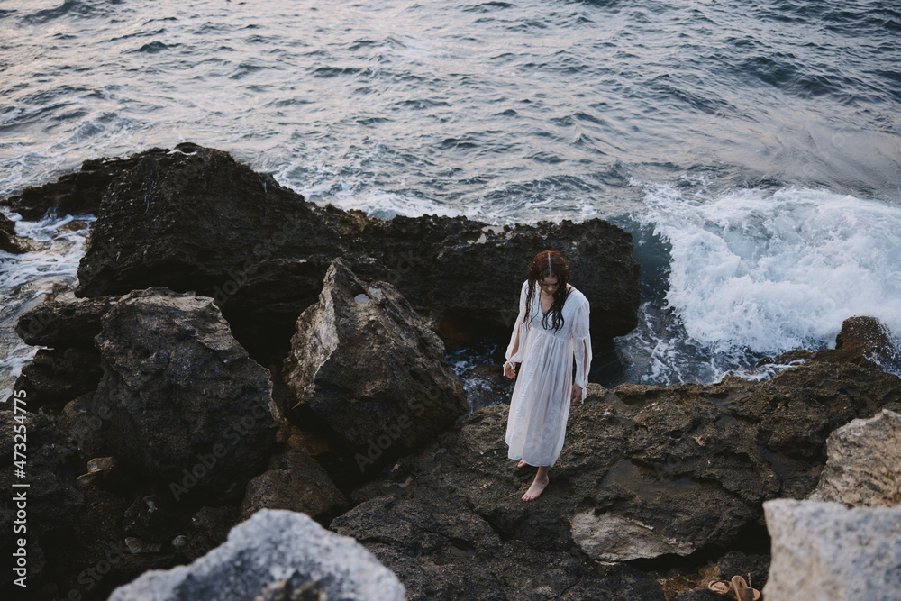 Woman in white dress rocks ocean nature travel