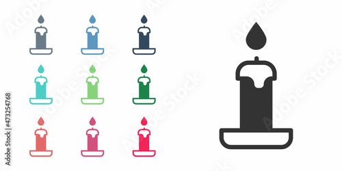 Black Burning candle in candlestick icon isolated on white background. Cylindrical candle stick with burning flame. Set icons colorful. Vector