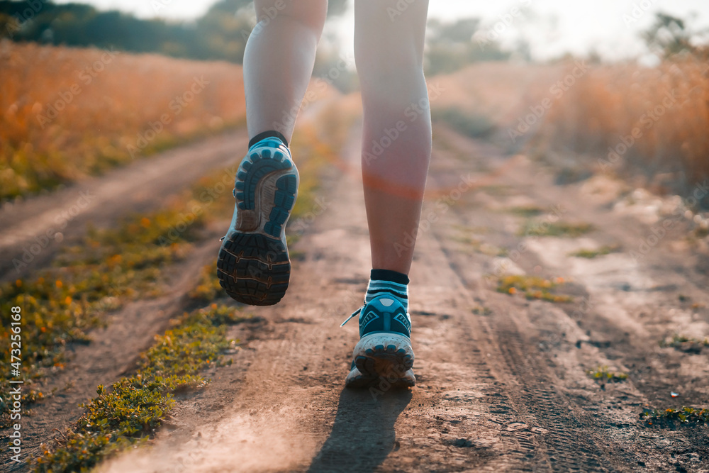 Young girl is running at sunset.