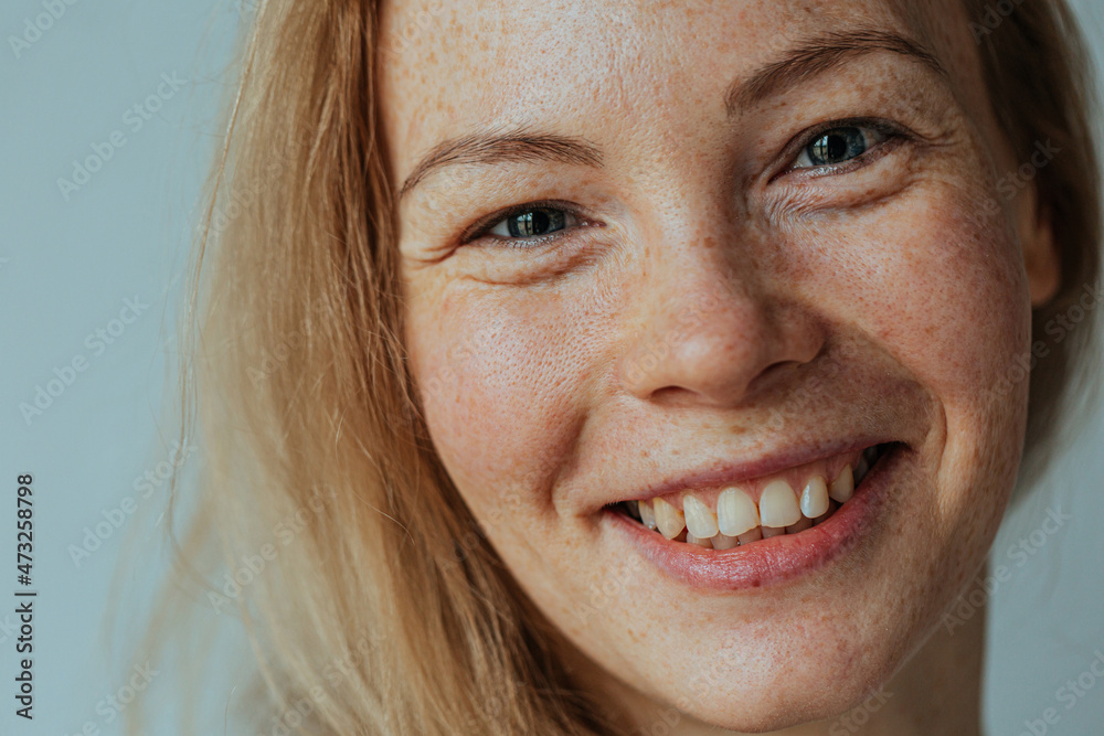 Overjoyed. Beautiful woman with read hair and freckles. Close up portrait against black background Overjoyed. Beautiful woman with read hair and freckles. Close up portrait against black background