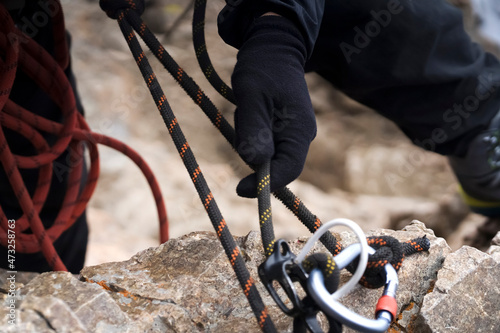 Climber is rappeling from the mountains summit.