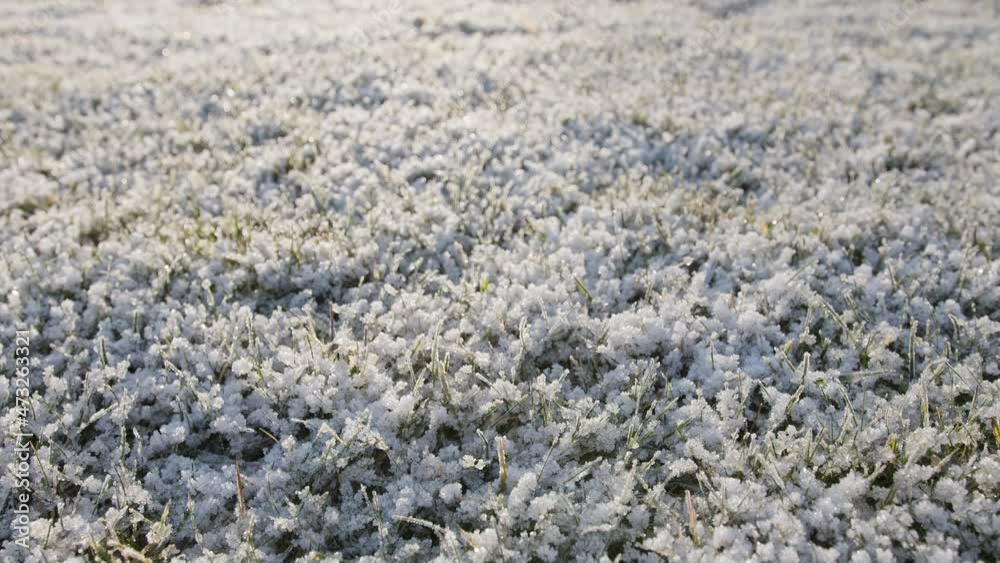 Slow camera movement along frozen grass with frost patterns on a sunny winter day. Great Christmas or New Year background. Slow camera movement along frozen grass with frost patterns on a sunny winter day. Great Christmas or New Year background.