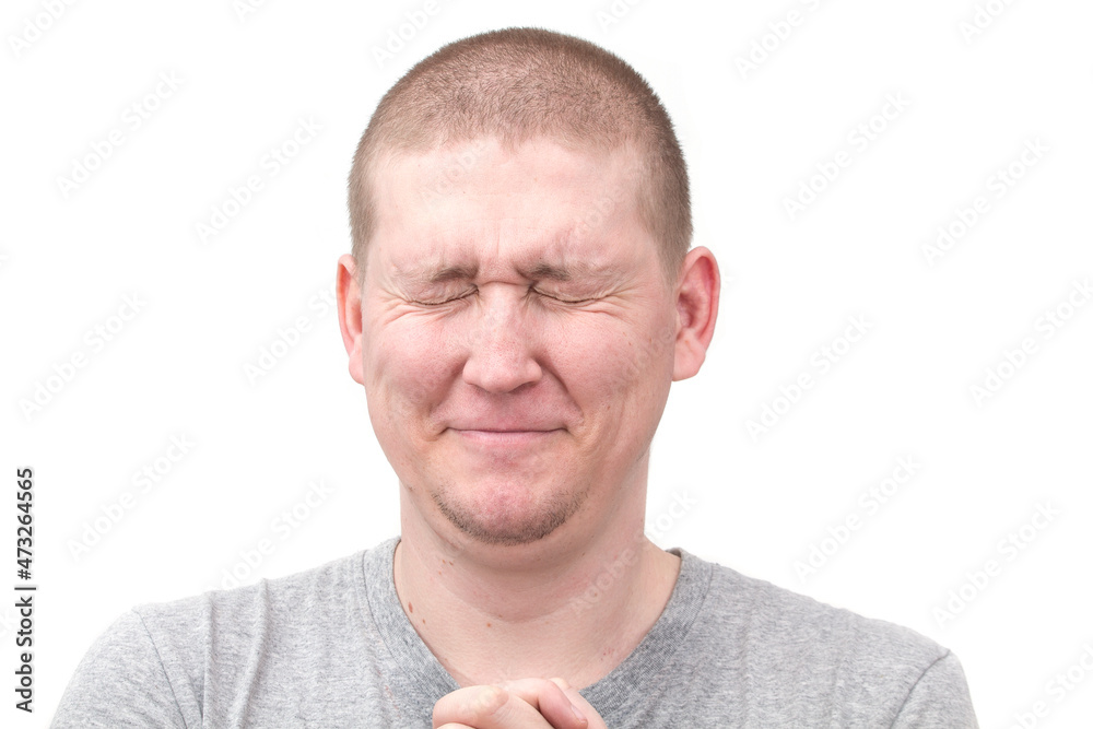 Obraz premium A man showing a facial expression, bursting out in laughter on a white background. 