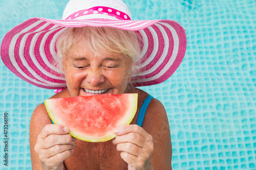 Happy senior woman at the swimming pool photo