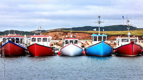 A row of colour fishing boats in the harbour of Havre Aubert, Magdalen Islands, Canada. photo