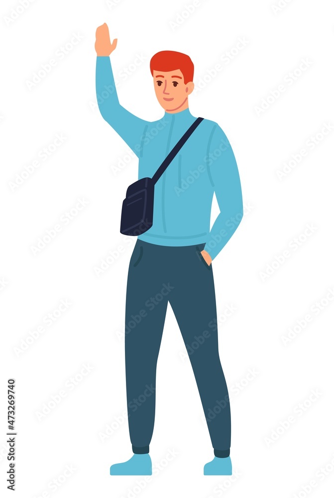Young man greeting with raised hand. Guy standing with neck pouch bag Young man greeting with raised hand. Guy standing with neck pouch bag