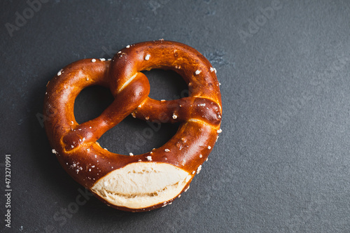 Homemade freshly baked soft pretzel on black backround. Traditional Bavarian pretzels for Octoberfest. Top view,copy space.