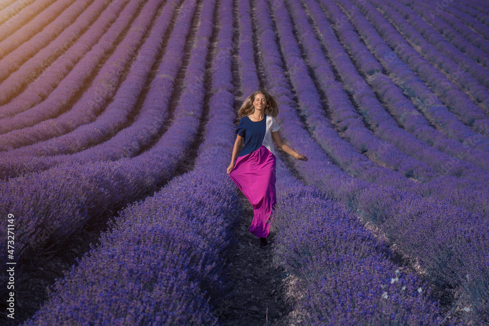 a girl in a dress on a lavender field. the woman runs. A handkerchief like wings a girl in a dress on a lavender field. the woman runs. A handkerchief like wings