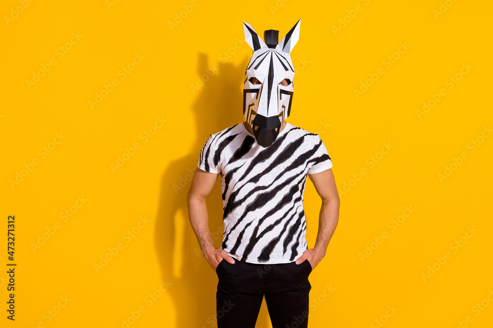 Photo of weird anonymous guy in zebra costume put hands pockets isolated over vivid yellow color background