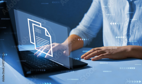 Online documentation database and document management system concept. Businesswoman working on laptop with virtual screen. Process automation to efficiently manage files. 