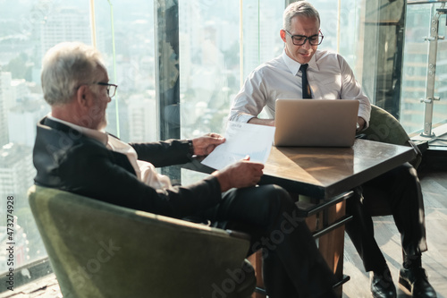 Two Senior businessman couple meeting in co working space or office