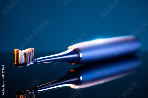 electric toothbrush on blue background