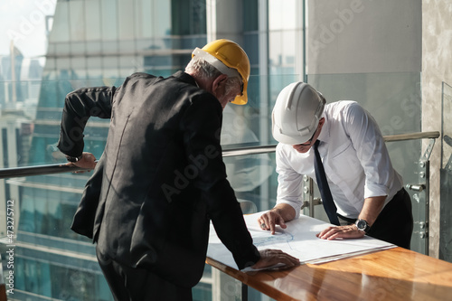 professional old architect and Senior foreman are talking the project