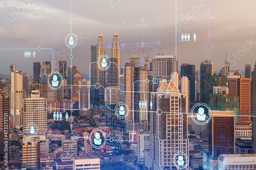 Photography Hologram of social media icons over sunset panoramic cityscape of Kuala Lumpur, Malaysia, Asia