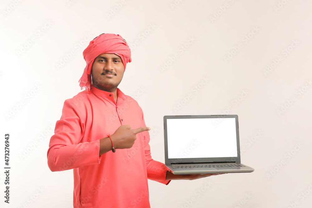 Indian farmer showing laptop screen on white background. Indian farmer showing laptop screen on white background.