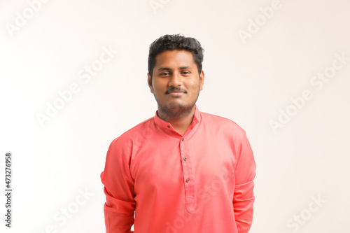 Young indian farmer giving expression on white background.