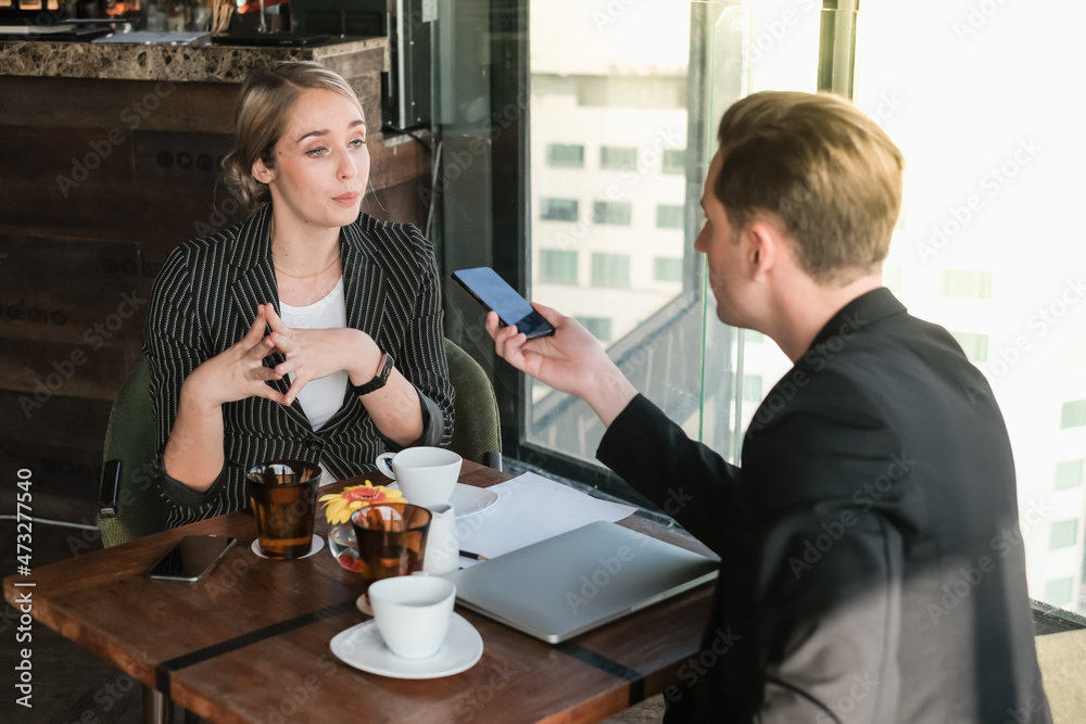 Two businessman and businesswoman couple meeting in co working space or office Two businessman and businesswoman couple meeting in co working space or office