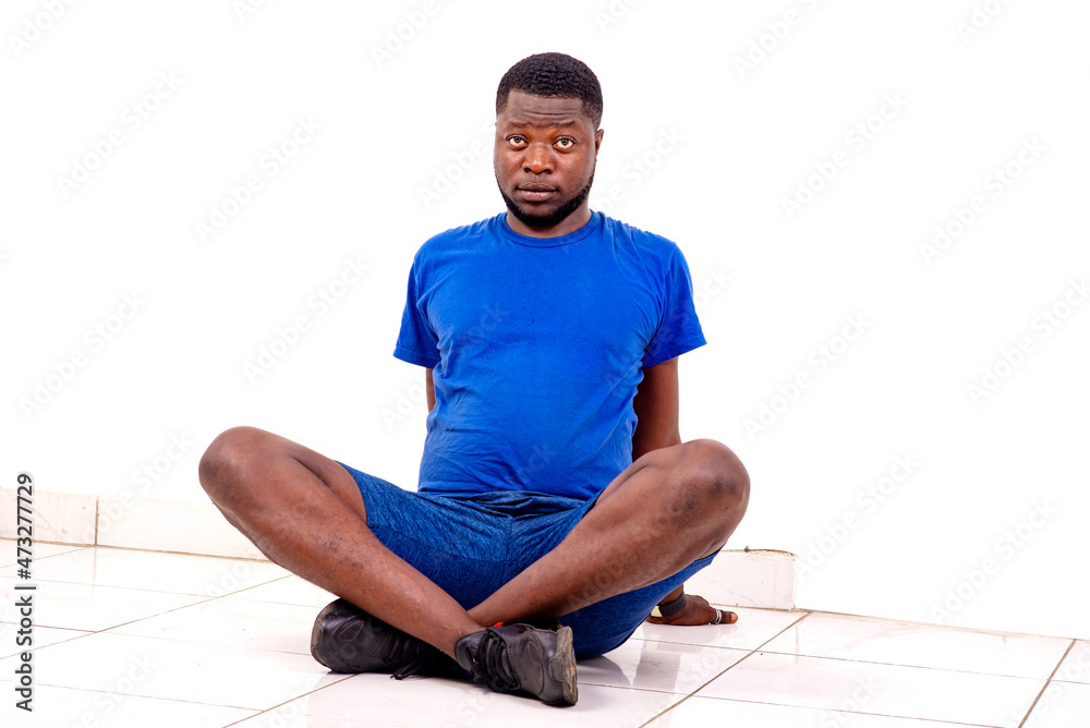 handsome sporty young man sitting on the floor. handsome sporty young man sitting on the floor.