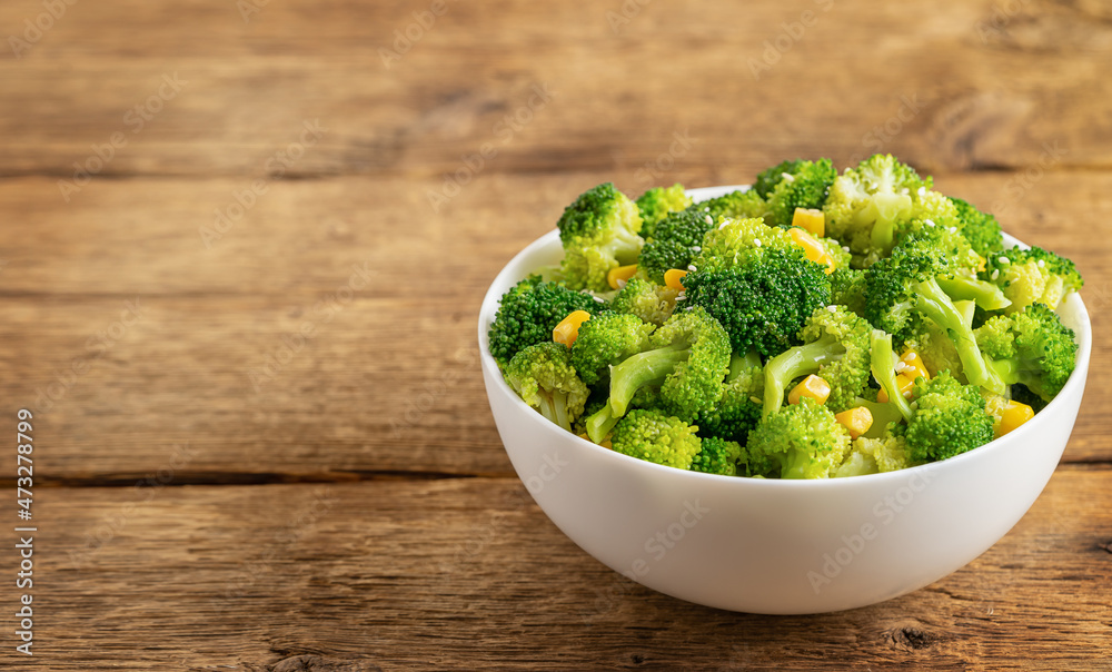 Bowl of broccoli salad on wooden background with copy space. Bowl of broccoli salad on wooden background with copy space.