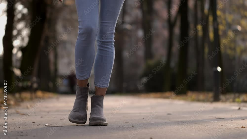 Close up unknown female walking in boots and jeans in autumn park in sunny weather. Front view of legs going alone outdoors. Female legs stepping confidently in autumn street
Close up unknown female walking in boots and jeans in autumn park in sunny weather. Front view of legs going alone outdoors. Female legs stepping confidently in autumn street