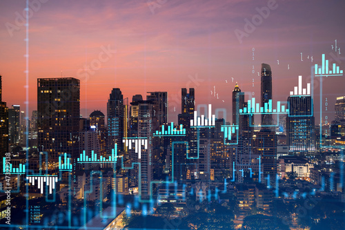 Market behavior graph hologram  sunset panoramic city view of Bangkok  popular location to achieve financial degree in Southeast Asia. The concept of financial data analysis. Double exposure.