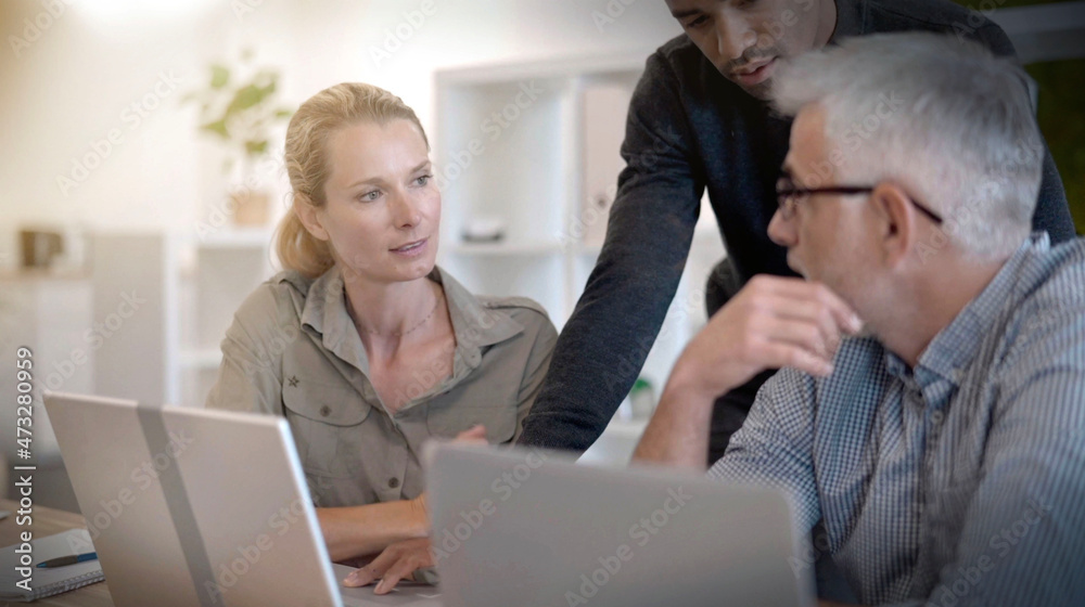 start-up in a team of three people working on a project start-up in a team of three people working on a project