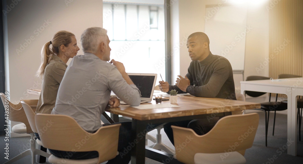 start-up in a team of three people working on a project start-up in a team of three people working on a project