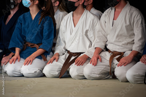 Athletes of Karate (brown belt) kneeling in Seiza position..