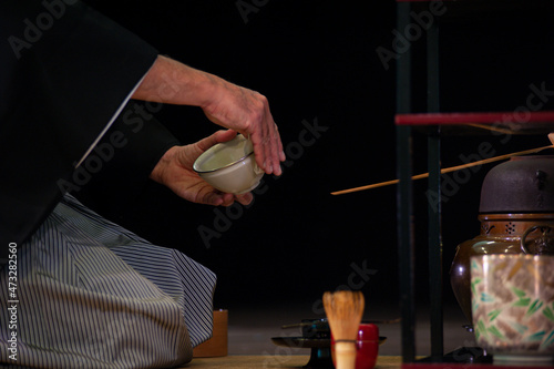 Japanese master in traditional kimono, during the tea ceremony. photo