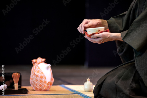 Japanese master in traditional kimono, during the tea ceremony. photo