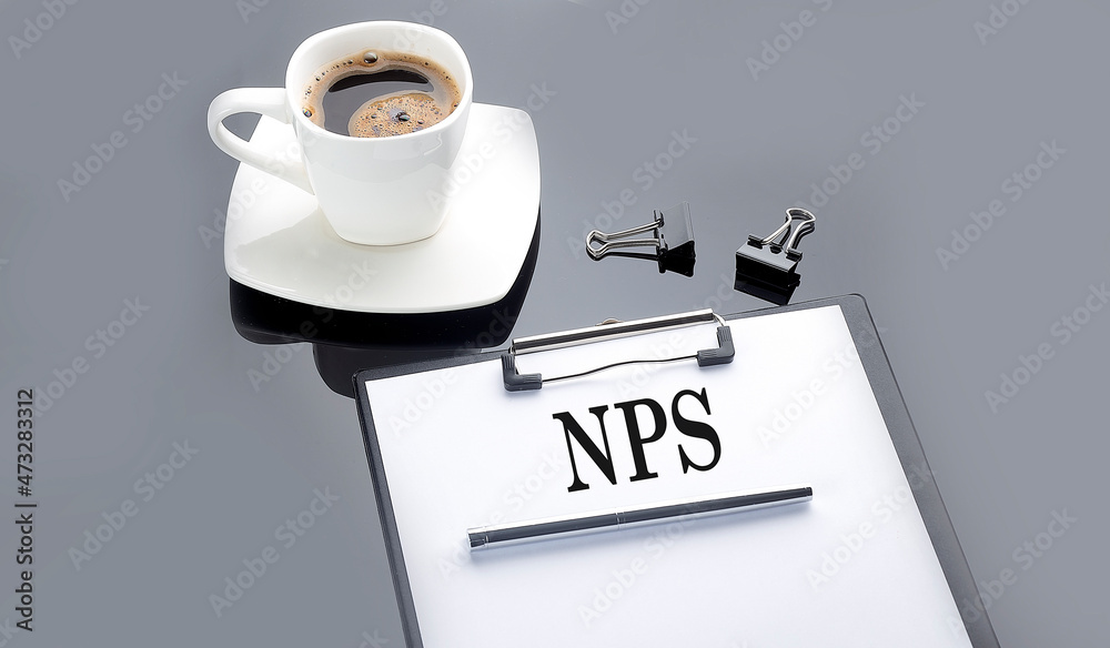 NPS NET PROMOTER SCORE text on paper sheet with coffee on the black background