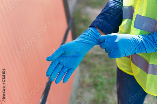 Industry worker putting on gloves
