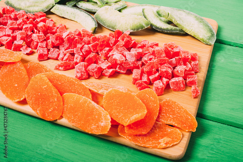 Mixture of dried fruit  on a colorful  wooden background.