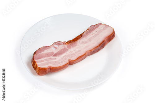 Piece of boiled smoked pork belly on a white dish