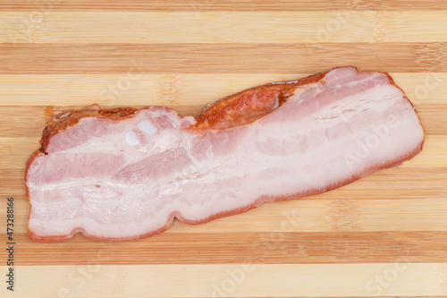 Top view of boiled smoked pork belly on cutting board