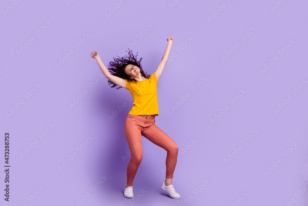 Full length photo of young excited woman good mood dance carefree isolated over violet color background