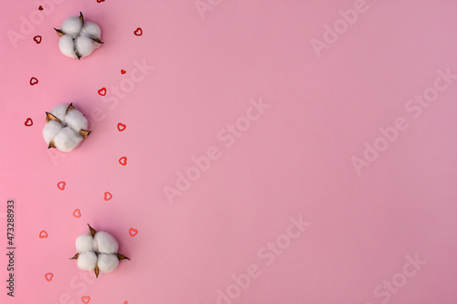 layout. Cotton flowers and small hearts on a pink background. Congratulations on wedding, on Valentine's Day. copy space. 