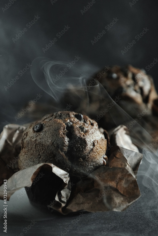 chocolate muffin with chocolate on a dark background chocolate muffin with chocolate on a dark background