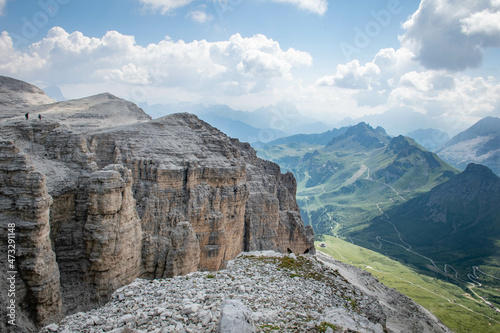 Dolomites, August, 2017, Passo Fedaia, view of the green valley from above and mountains in the distance