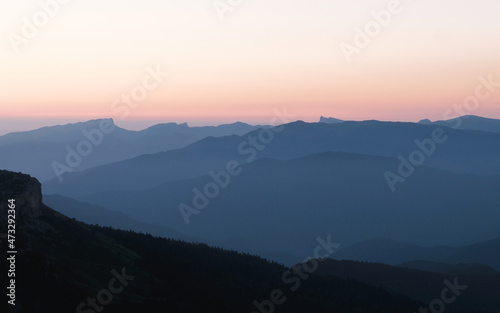 Mountain silhouette layers in the sunset light. Beautiful photography of the nature  blue layered background. Natural gradient.
