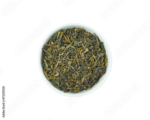 Dry green tea in white bowl isolated on white background. Healthy drink.