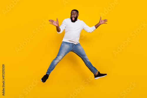Full length portrait of handsome excited person raise rams palms open mouth rejoice isolated on yellow color background © deagreez