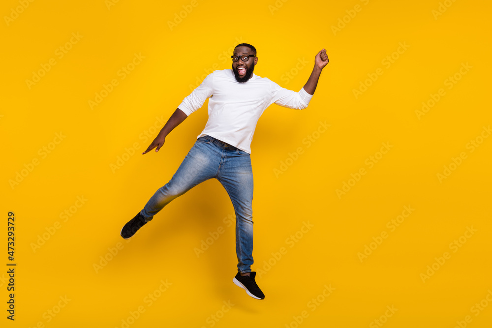 Full length photo of crazy handsome guy arm hold empty space umbrella isolated on yellow color background