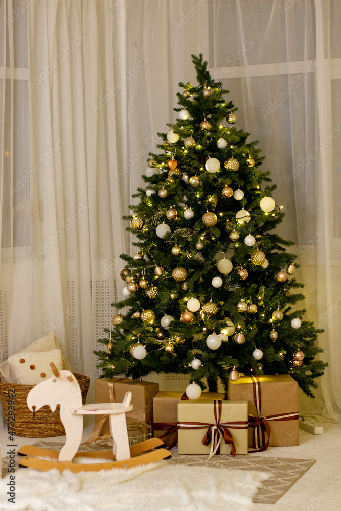 Decorated Christmas tree with gifts in the room