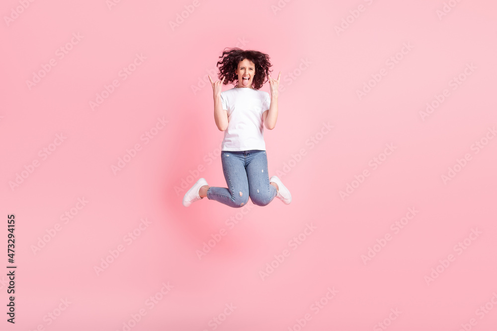 Full body photo of young pretty girl jump stick-out show fingers brutal rock symbol isolated over pink color background